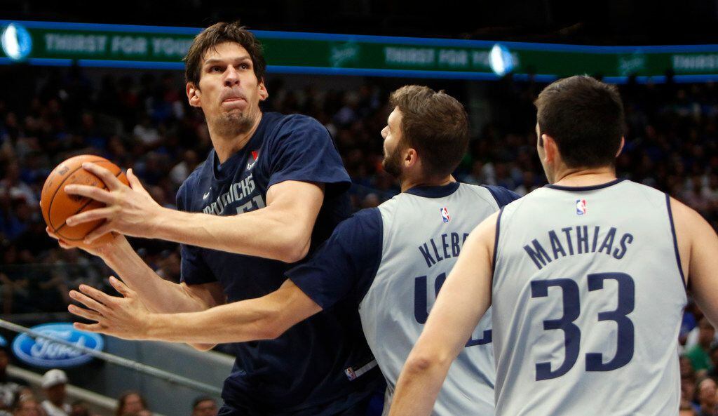 Dallas Mavericks center Boban  Marjanovic' (51) looks to shoot as he is defended by forward...