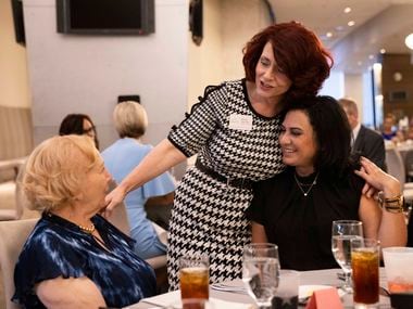 Operations manager Mona Harmon (center) greets realtor Betsy Davila (right) and her mother Elsa Casanova during the CENTURY 21 Judge Fite top awards dinner and social event on Aug. 31 at AT&T Stadium in Arlington.
