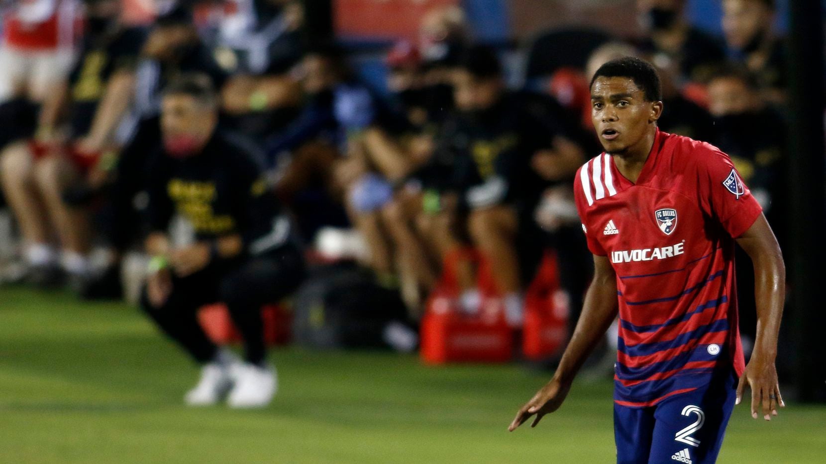 FC Dallas defender Reggie Cannon (2) stays alert in front of the team bench during first...