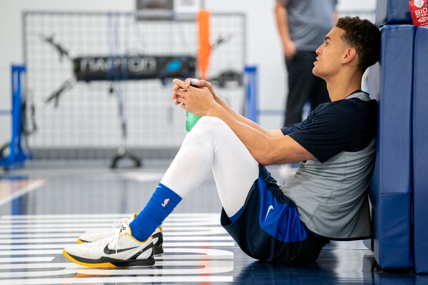 Dallas Mavericks center Dwight Powell (7) rests against the goal standard during a training...