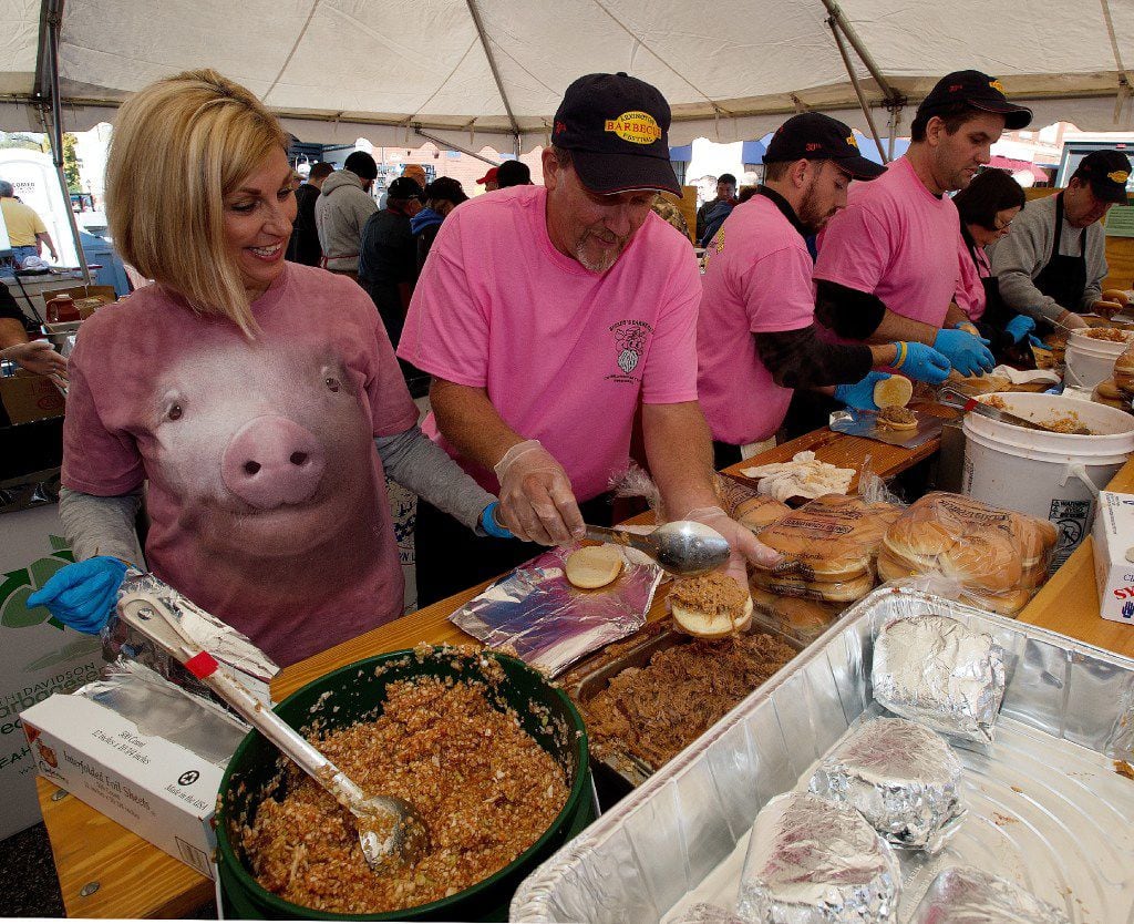 Speedy's Barbecue workers make barbecue sandwiches in one of the barbecue tents during the...