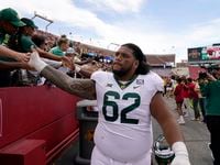Baylor defensive lineman Siaki Ika (62) celebrates with fans after an NCAA college football...