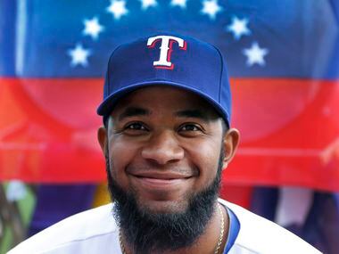 Texas shortstop Elvis Andrus poses with the Venezuelan flag at photo day during Texas...