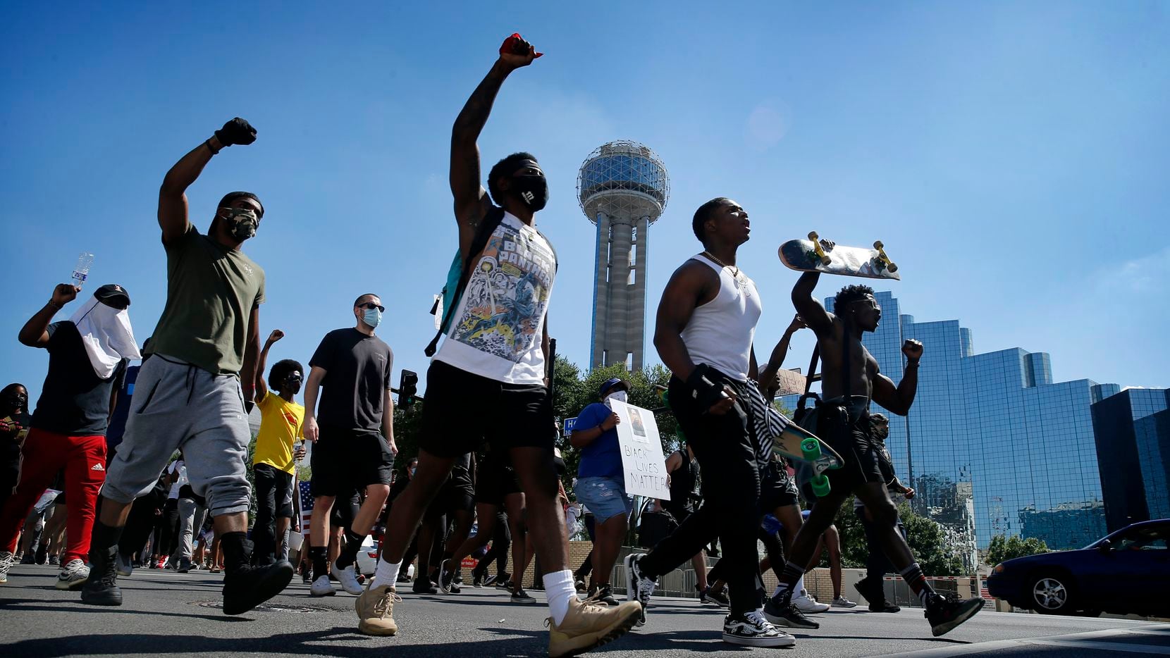 Protesters supporting Black Lives Matters rally march past Reunion Tower on their way to...