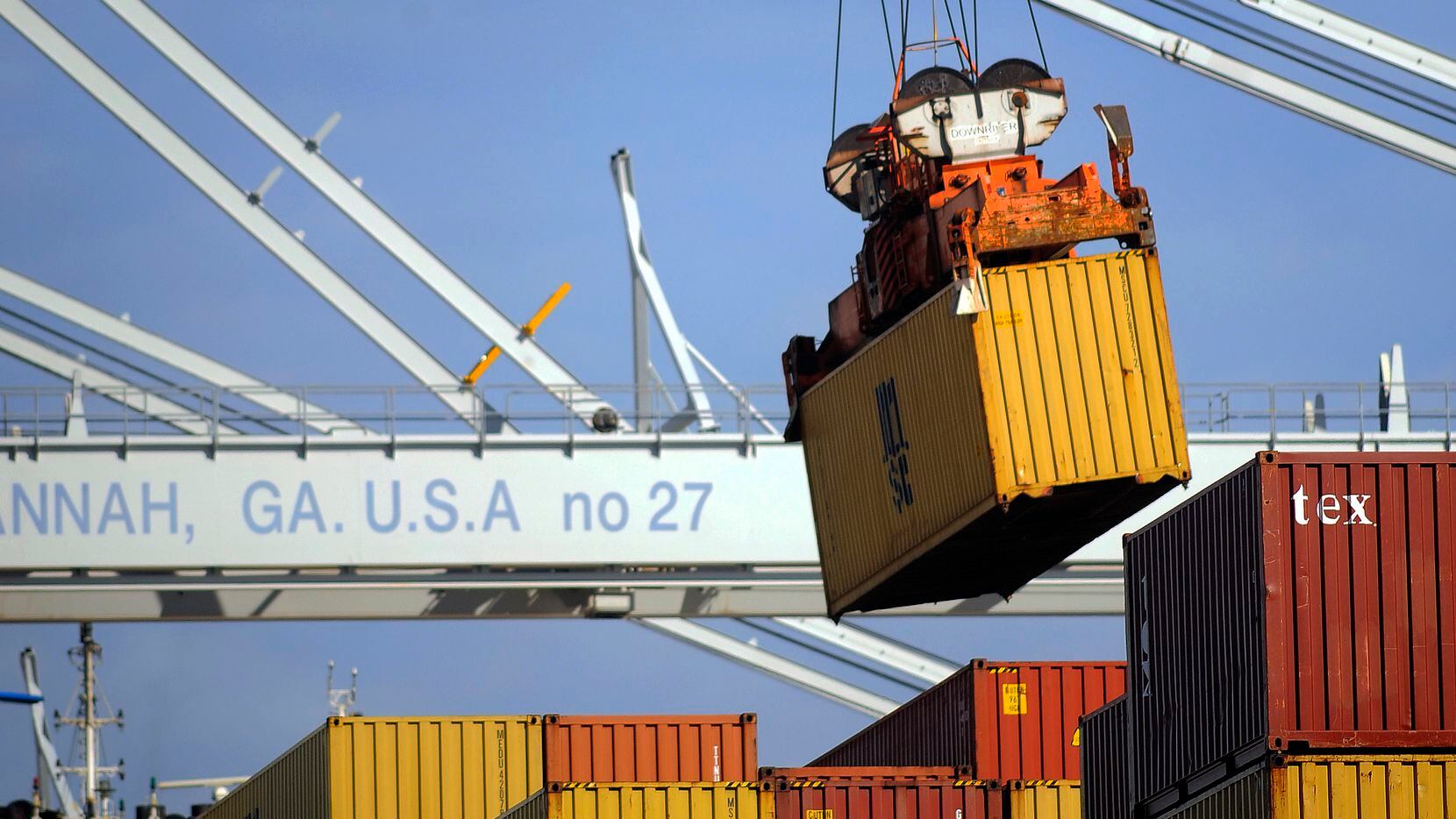 In this Monday, Jan. 27, 2014, photo, a ship to shore crane unloads a shipping container at the Georgia Ports Authority Garden City terminal, in Savannah, Ga. The Commerce Department reports on the U.S. trade deficit for December on Thursday, Feb. 6, 2014. (AP Photo/Stephen B. Morton)