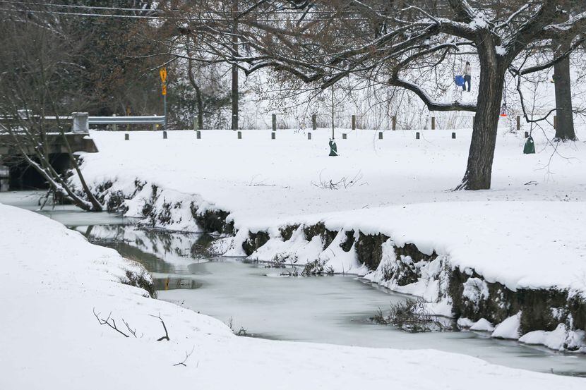 Frozen water stream on Williamson Branch after an overnight snow storm at White Rock Lake in...