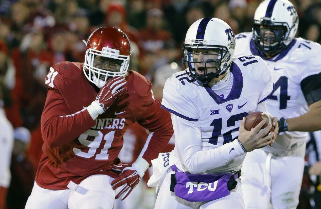 TCU quarterback Foster Sawyer (12) is chased down by Oklahoma defensive end Charles Tapper...