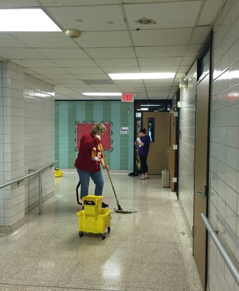 Garfield Elementary Principal Courtney Merilatt works on cleanup efforts at her Houston...