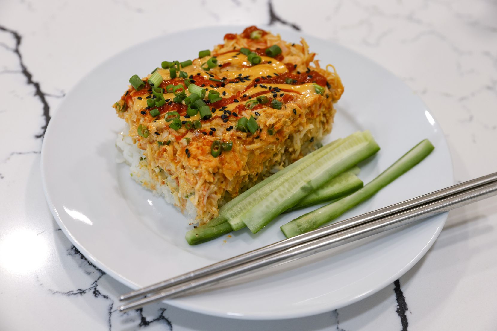 A piece of sushi bake, a casserole of salmon, imitation crab and rice.