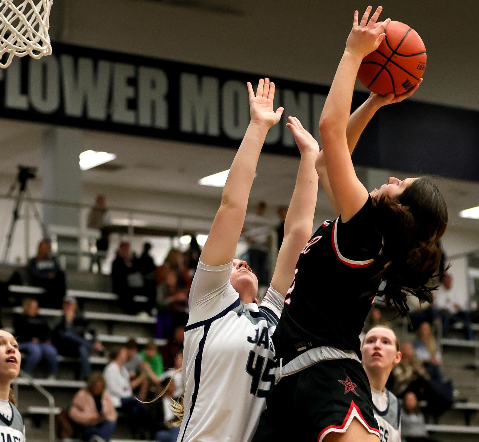 Coppell guard Waverly Hassman, (right) tries to shoot over Flower Mound forward Natalie...