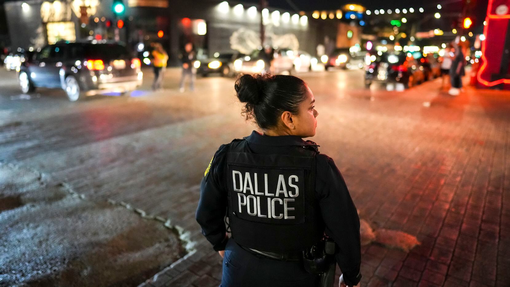Dallas police officer Irma Jaquez looks out on the intersection of Main Street at Malcolm X...