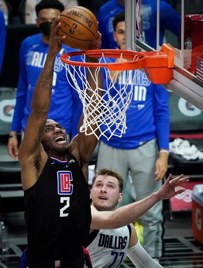 LA Clippers forward Kawhi Leonard (2) dunks the ball past Dallas Mavericks guard Luka Doncic (77) during the second half of an NBA playoff basketball game at Staples Center on Tuesday, May 25, 2021, in Los Angeles. The Mavericks won the game 127-121.