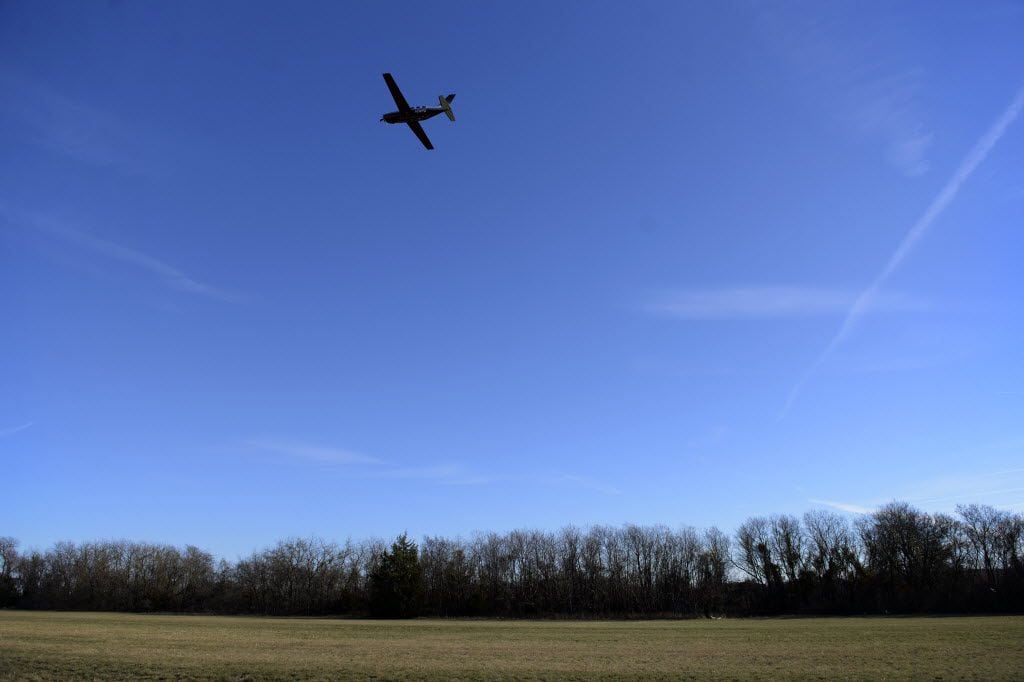 A plane takes off over the grass portion of the runway at Aero Country Airport in McKinney,...