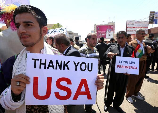 Iraqi Kurds and Iraqi Christians display signs thanking America during a demonstration in front of the U.S. General Consulate in Arbil, the capital of the autonomous Kurdish region of northern Iraq.
