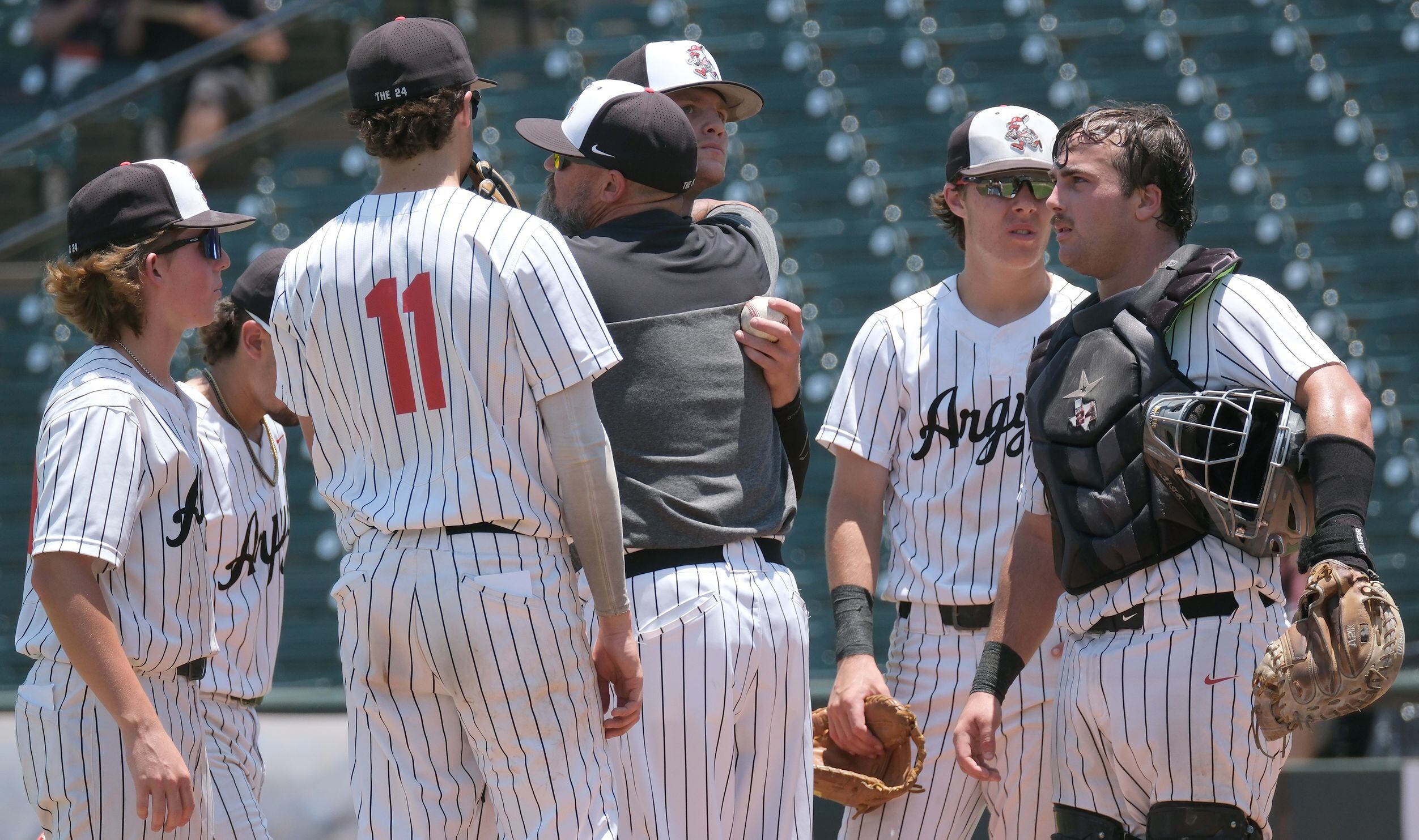 Argyle head coach, Ricky Griffin, gives pitcher Alex D’Angelo, (2), a hug after being pulled...