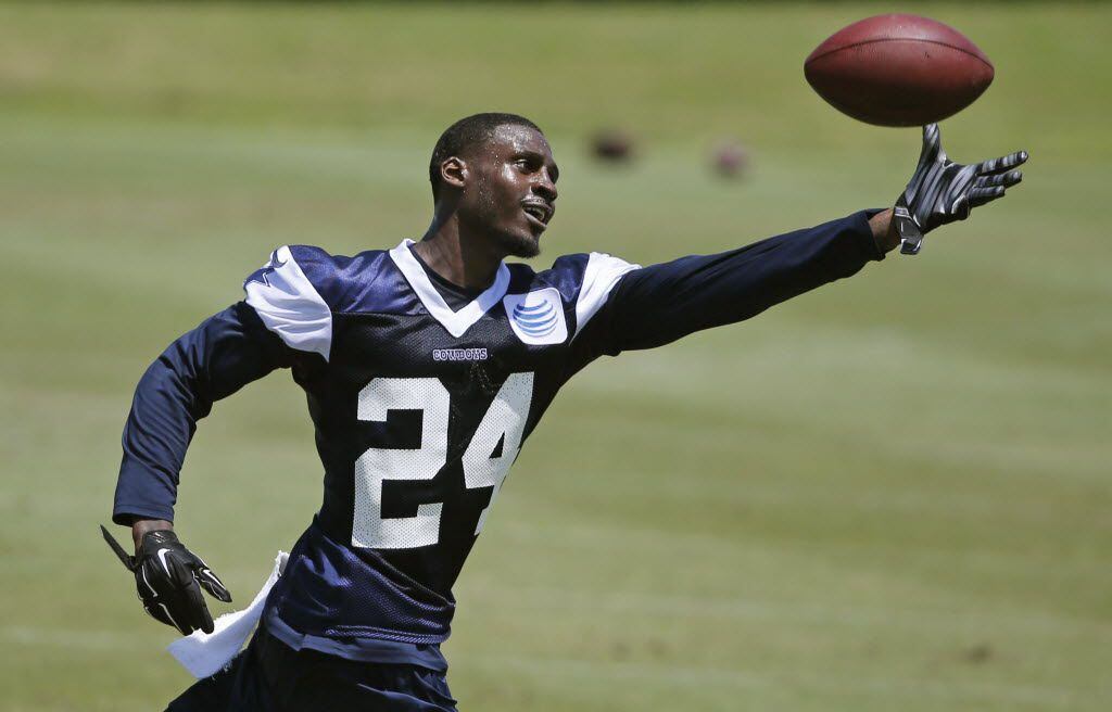 Dallas Cowboys cornerback Morris Claiborne (24) catches the ball as he works by himself during the teams' OTA workout at Valley Ranch in Irving, Texas on Wednesday, May 27, 2015. (Louis DeLuca/The Dallas Morning News)