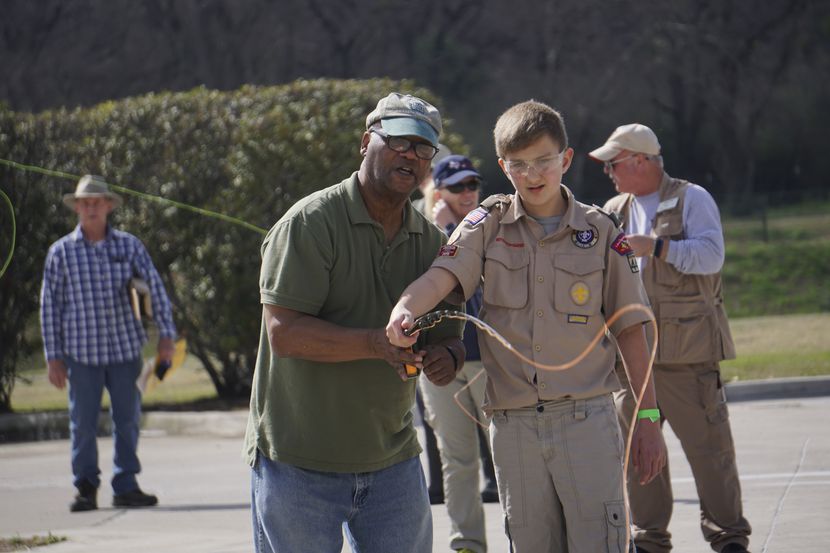 Alfred Hillman teaches Zachary Bruce how to cast during Flyfest at River Park Trailhead in...