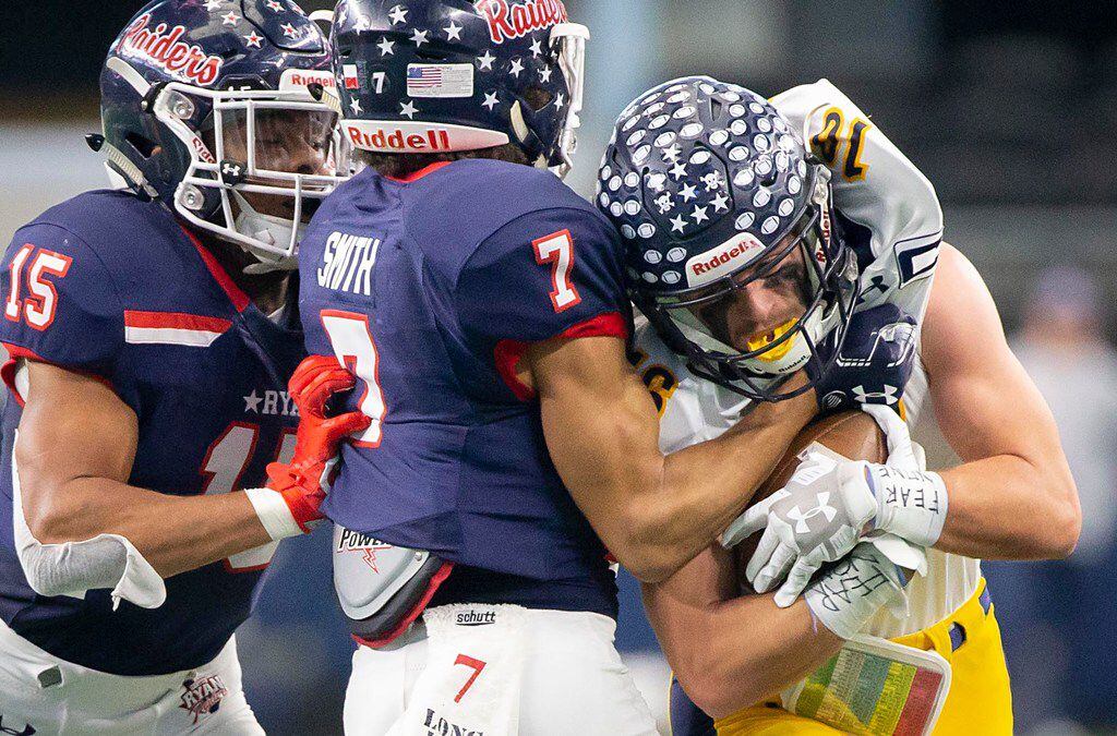 Highland Park wide receiver Finn Corwin (16) is wrapped up by Denton Ryan's Tra Smith (7)...
