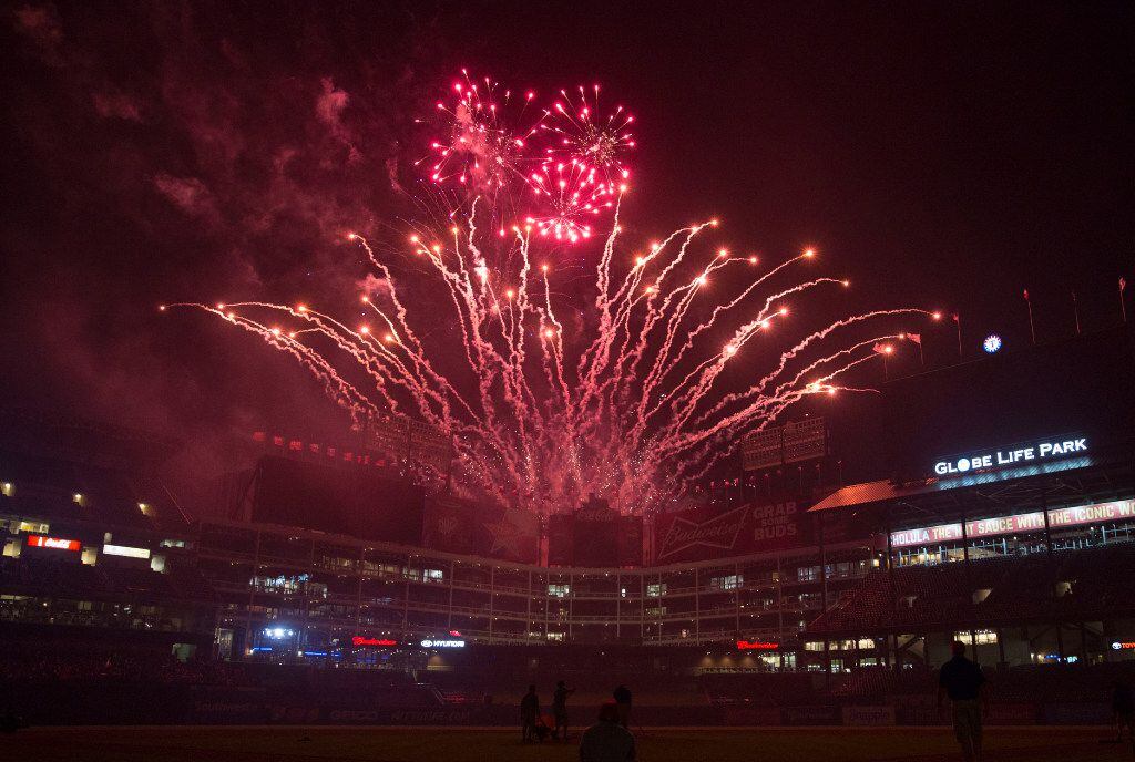 Fireworks illuminate the sky during a post-game show following the Texas Rangers and Oakland...