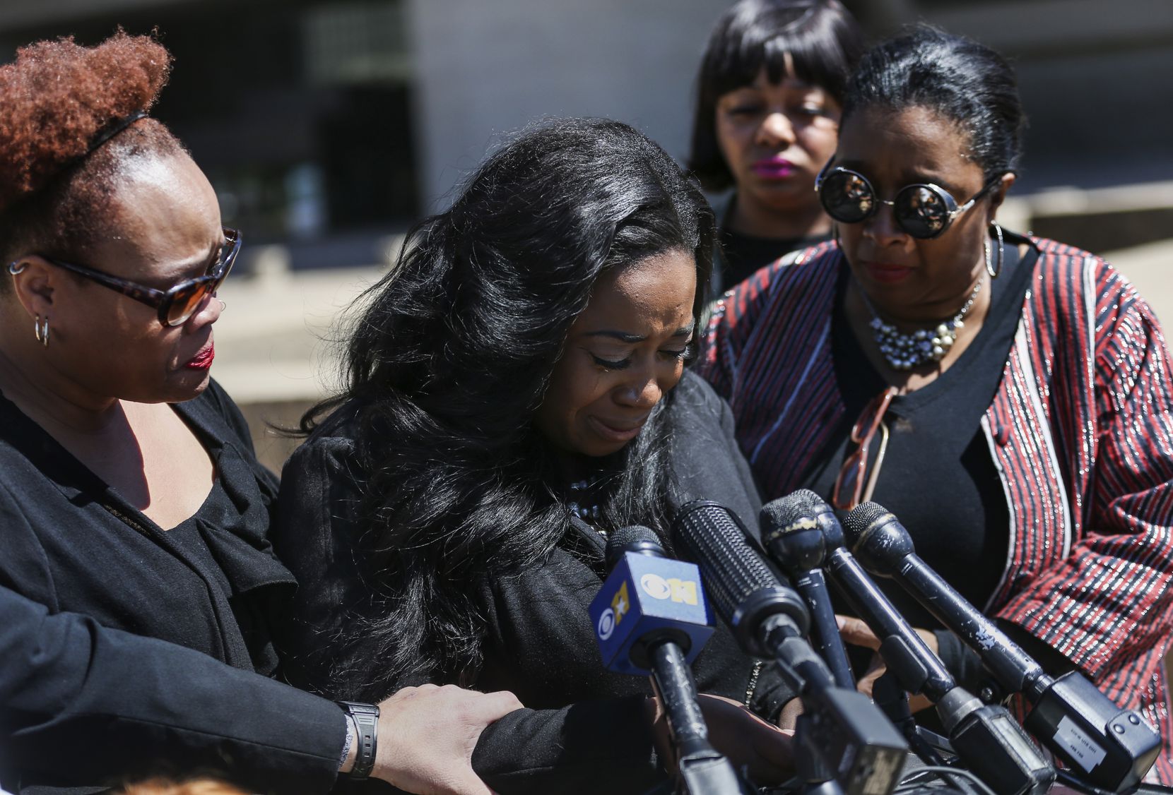 Supporters surround Keyaira Saunders as she speaks during a news conference at Dallas City Hall on April 19.
