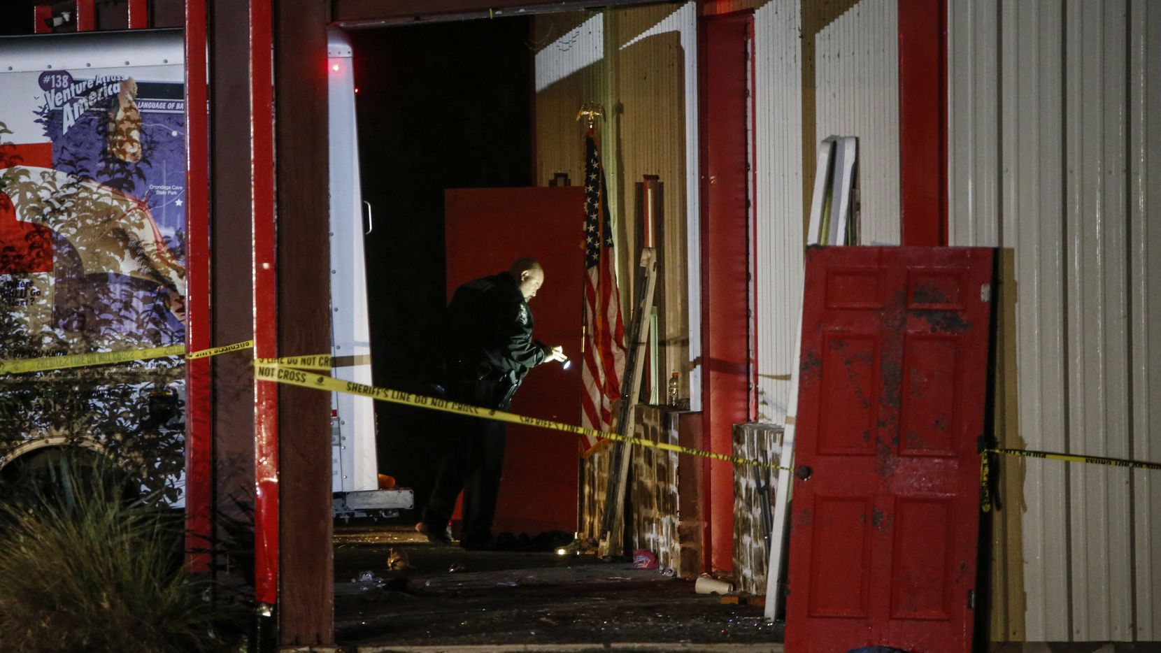 Officials work a crime scene after a shooting at Party Venue on Highway 380 in Greenville, Texas, on Sunday, October 27, 2019. As of early Sunday morning a gunman is still at large after killing at least two people and injuring 14 at Party Venue Saturday night, according to Hunt County Sheriff Randy Meeks.