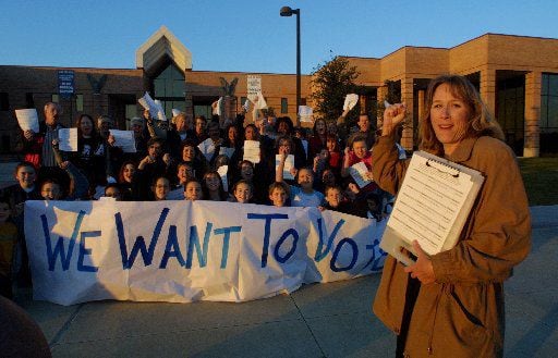 This 2002 photo shows how Brenda Rizos' civic activism began. She led a petition drive seeking the right to vote on whether to keep middle and high school students at Allen High or create a Lovejoy ISD secondary school. She's been an ISD activist ever since, frustrating then- Lovejoy ISD Superintendent, Ted Moore. 