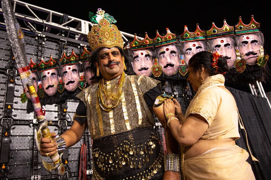 Mangala Kagal helps Dr. Prakash Kagal straighten his Ravana costume, a 10-headed demon portrayed in Ramlila.