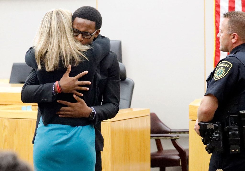 Botham Jean's younger brother Brandt Jean hugs convicted murderer Amber Guyger after delivering his impact statement to her following her 10-year prison sentence for murder at the Frank Crowley Courts Building in Dallas, Oct. 2, 2019. Brandt asked the judge if he could give Guyger a hug. The fired Dallas police officer was found guilty of murder by a 12-person jury. Guyger shot and killed Botham Jean, an unarmed neighbor in his own apartment last year. She told police she thought his apartment was her own and that he was an intruder.