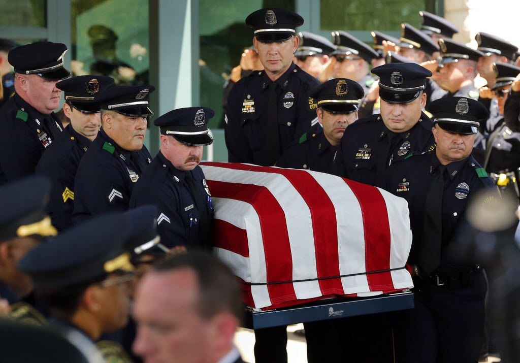 Police pallbearers with the casket of Lorne Ahrens at Prestonwood Baptist Church in Plano on Wednesday.