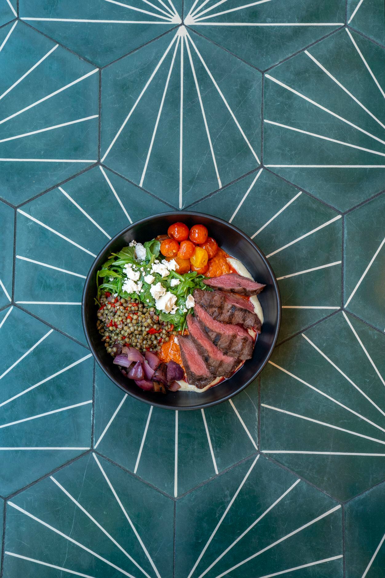 A steak bowl, an item on the lunch menu, is shown at Sachet, a Mediterranean restaurant,...