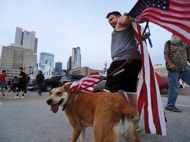 Clad in U.S. flags, Jason Hone of Oak Cliff  arrives to the March Against White Supremacy...