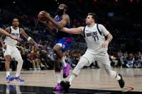 Dallas Mavericks guard Luka Doncic (77) defends against LA Clippers guard James Harden (1)...