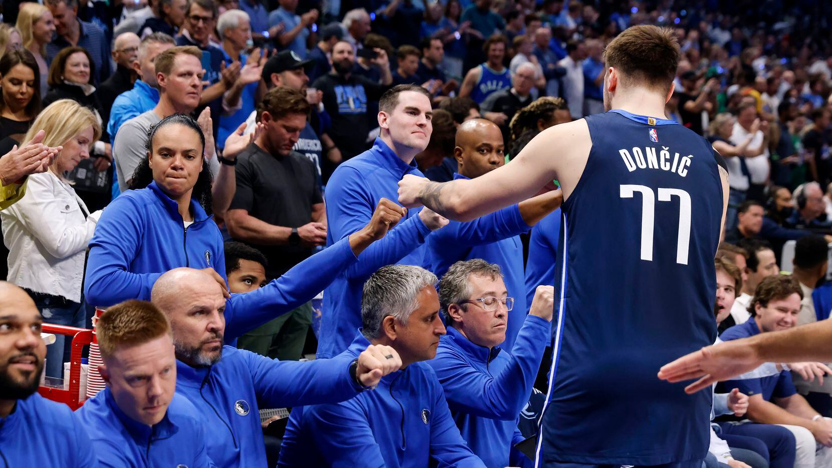 Dallas Mavericks guard Luka Doncic (77) receives first bumps from coaches before facing the...