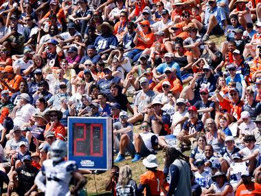  Denver Broncos and Dallas Cowboys fans line the hillside to watch a joint practice at the...