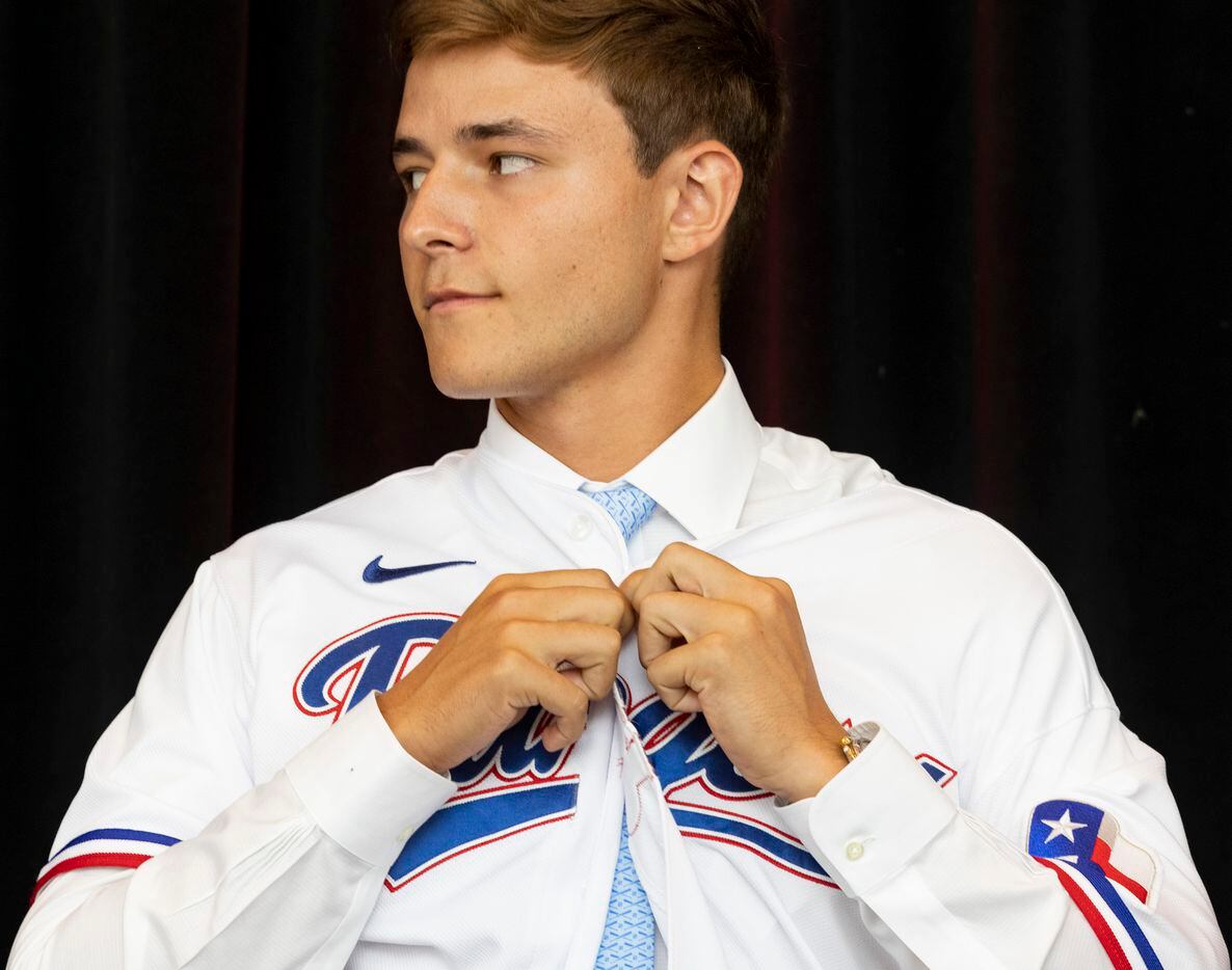 Right-handed pitcher Jack Leiter from Vanderbilt University puts on his Texas Rangers jersey...