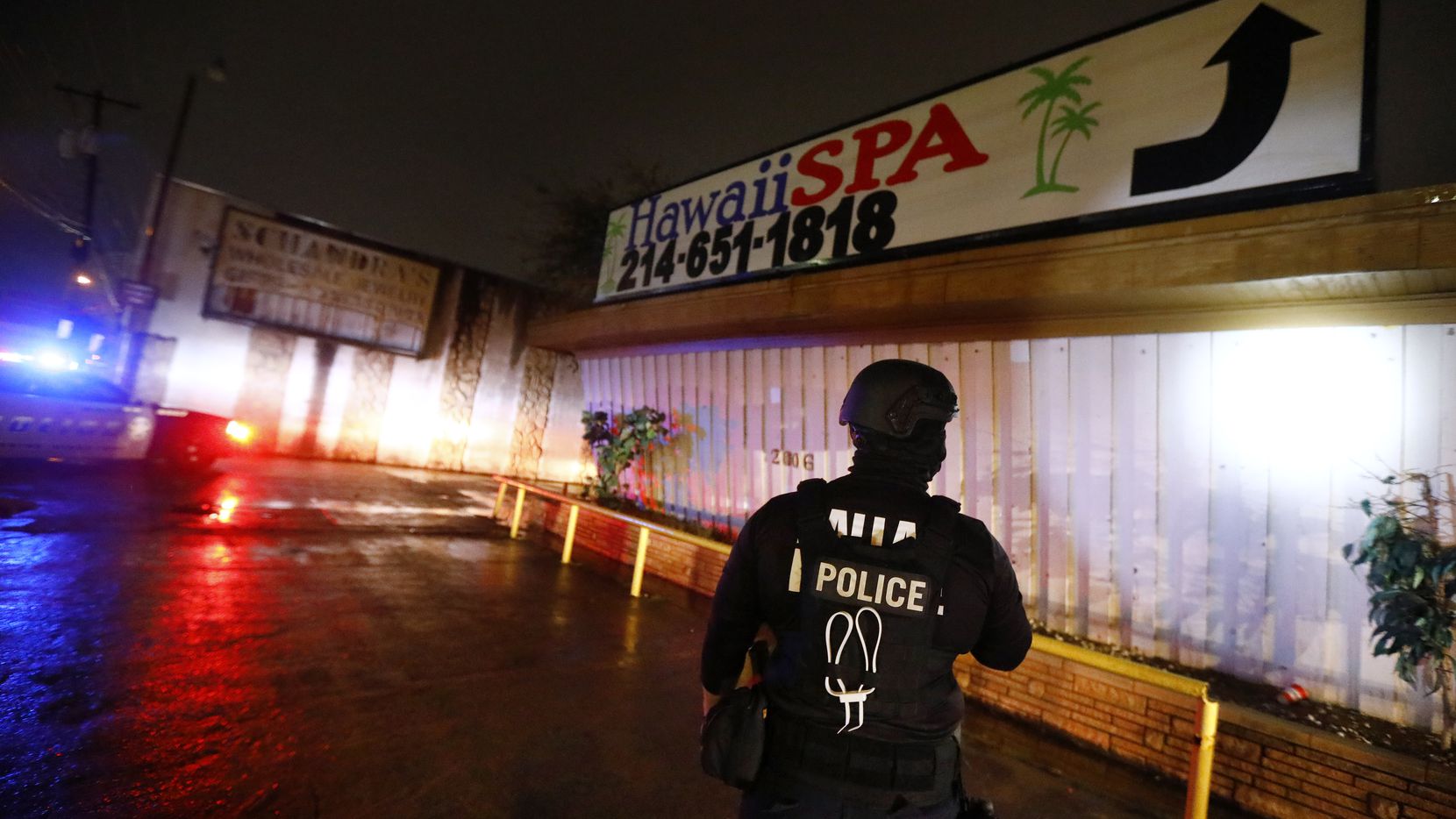A Dallas Police vice officer inspects the outside of Jade Spa, one of the longest-running...