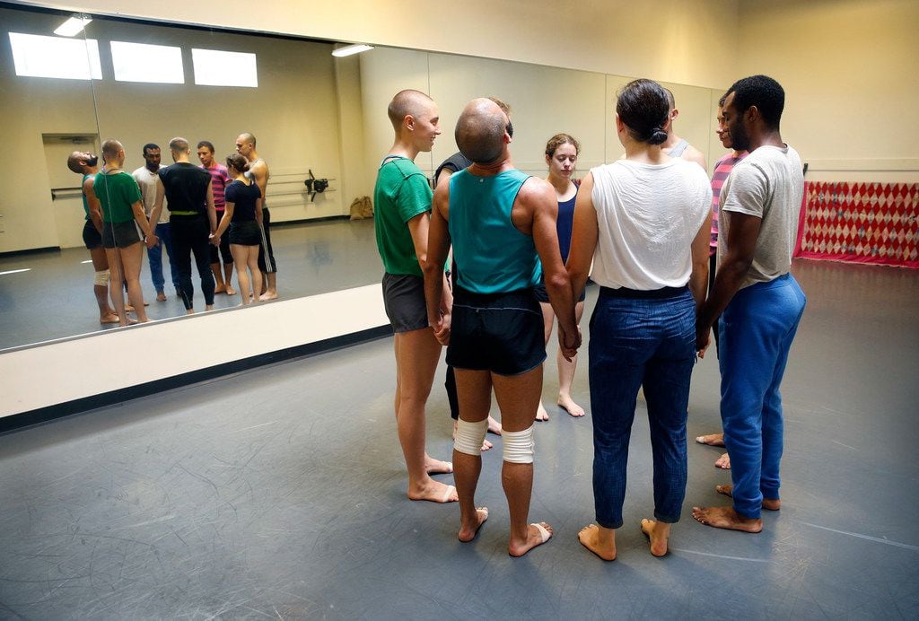 Dark Circles Contemporary Dance company members join hands at Preston Center Dance before a...