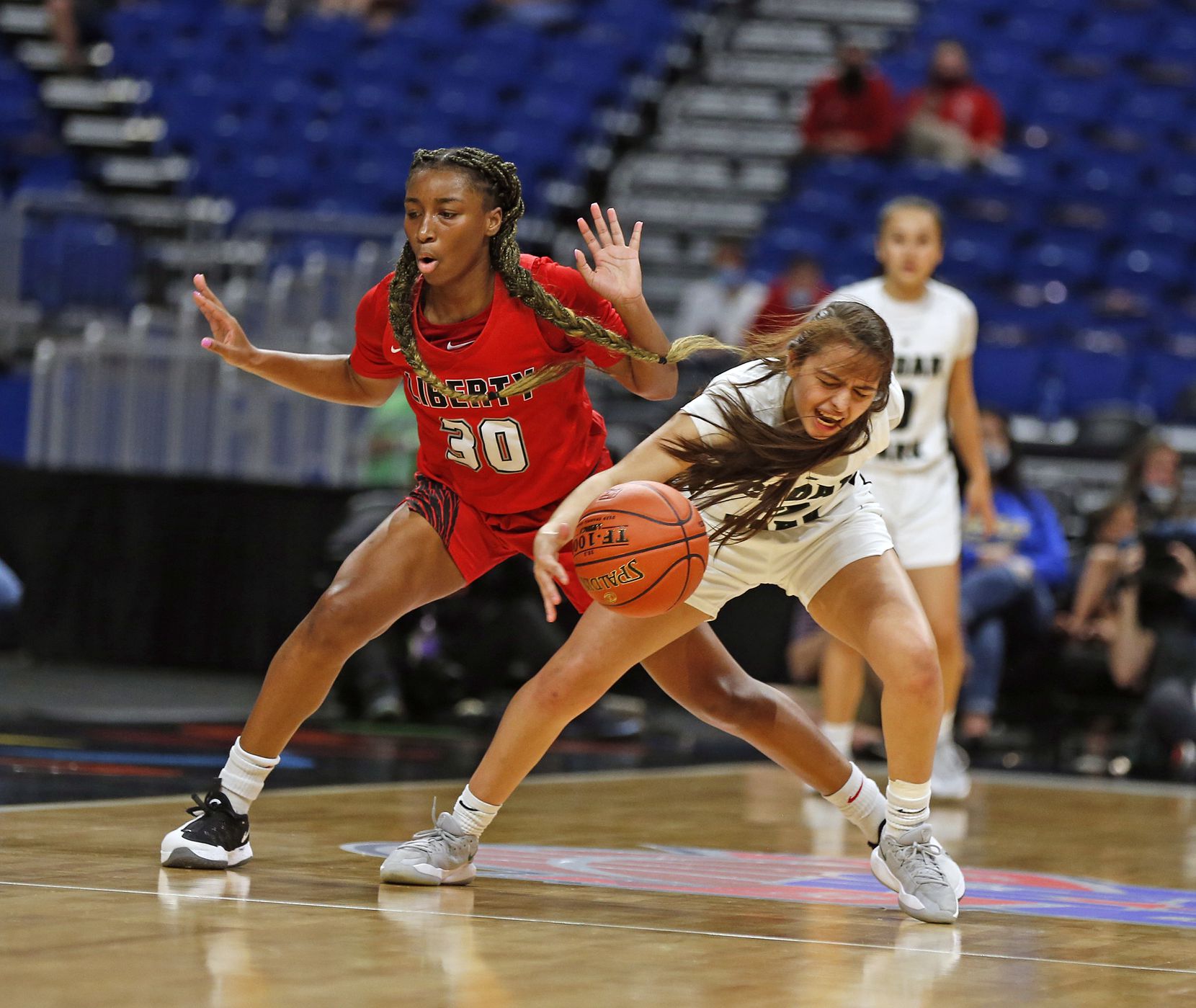 Frisco Liberty’s Jazzy Owens-Barnett (left) tried for a steal on Sarai Estupinan of  Cedar Park in the Class 5A state championship game on March 11 at the Alamodome in San Antonio. No. 1-ranked Cedar Park stopped defending champ Frisco Liberty 46-39 to win.