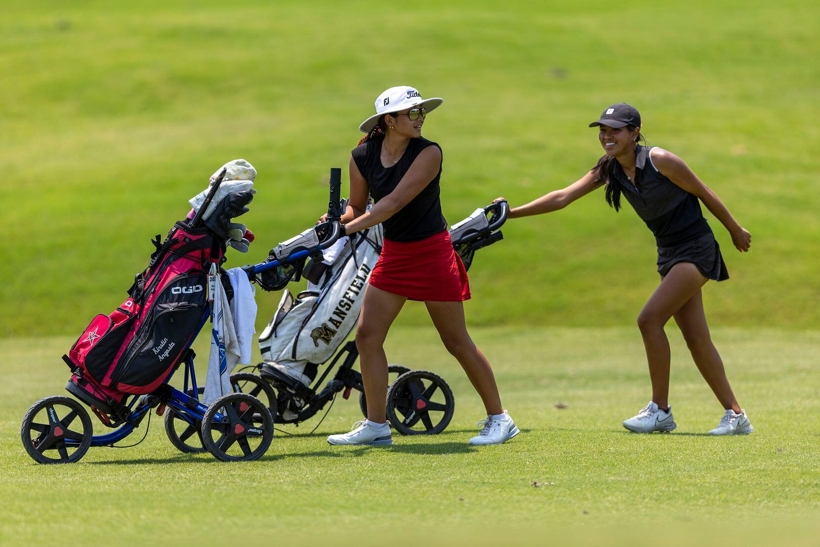Coppell’s Kristin Angosta, left, and Mansfield’s Madison Le walk to their shots on the 7th...