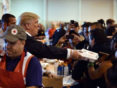 President Donald Trump serves food to Hurricane Harvey victims at NRG Center in Houston on...