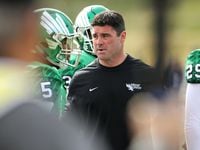 North Texas coach Seth Littrell walks among his players on the sideline during a loss to...