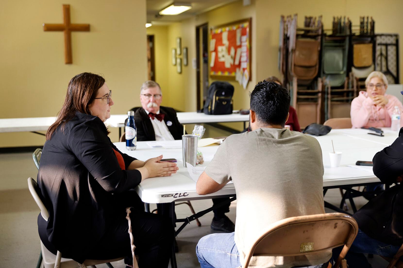 Rev. Rachel Ringlaben (left) leads a discussion with Venezuelan immigrants who sought legal...