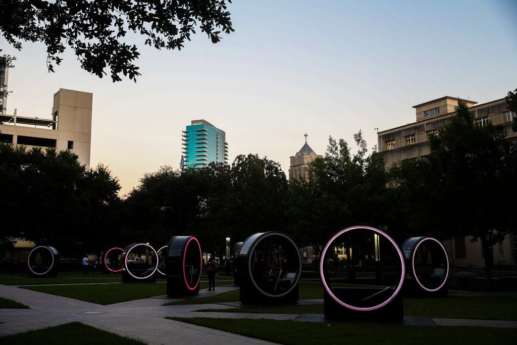 Rings are illuminated at dusk for the "Loop" interactive art display at Burnett Park.