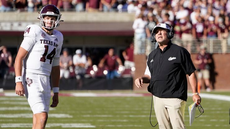Texas A&M quarterback Max Johnson (14) confers with head coach Jimbo Fisher during the first...