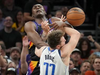 Phoenix Suns center Bismack Biyombo (18) fouls Dallas Mavericks guard Luka Doncic (77)...