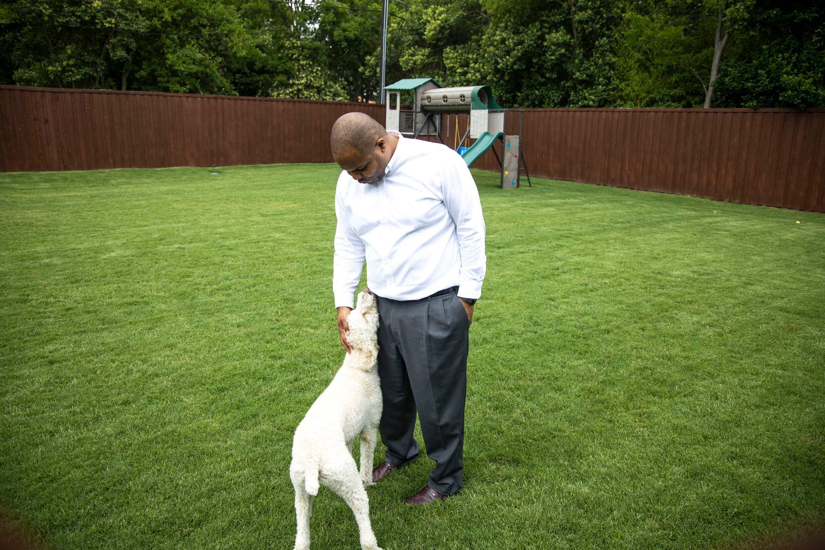  Eric Johnson with his new dog, Penny, in the backyard of his East Dallas home. (Shaban Athuman/Staff Photographer)