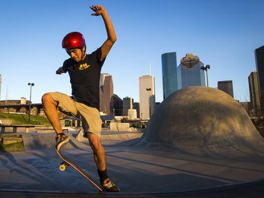 August Guerrero rides in the shadow of the downtown skyline at Lee and Joe Jamail Skatepark...