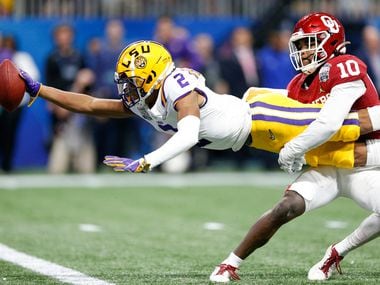 FILE - LSU wide receiver Justin Jefferson (2) extends for a touchdown while Oklahoma safety Pat Fields (10) attempts to tackle him during the first half of the Peach Bowl in Atlanta on Saturday, Dec. 28, 2019.