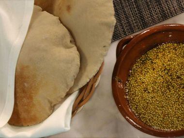 Freshly baked pita bread and za'atar land on every table, a lovely welcome.