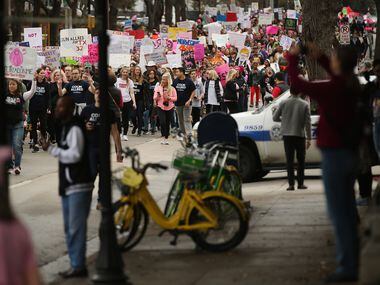 Marchers move Uptown during the Dallas Women's March in Dallas Saturday.